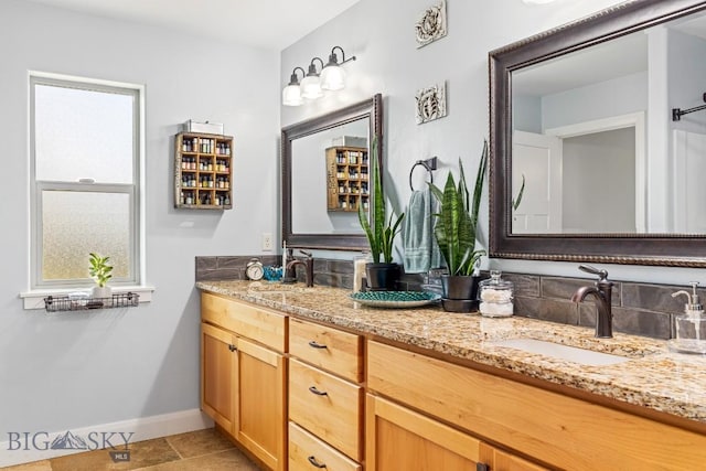 1708 Drummond Blvd, Belgrade, MT 59714 - full bathroom with baseboards, double vanity, and tile patterned flooring