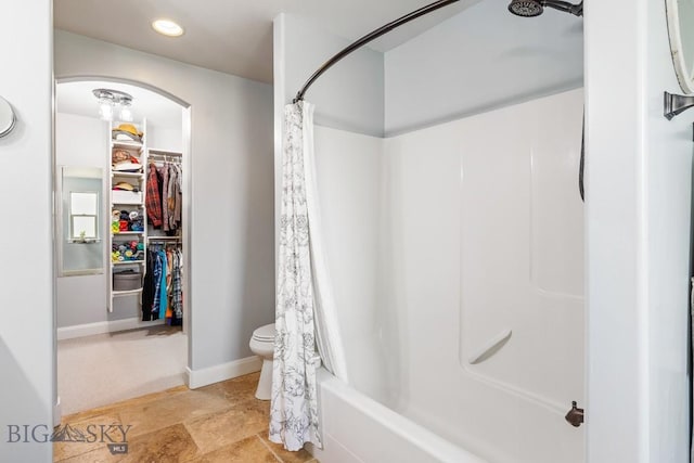 1708 Drummond Blvd, Belgrade, MT 59714 - bathroom featuring a walk in closet, recessed lighting, toilet, shower / bathtub combination with curtain, and baseboards