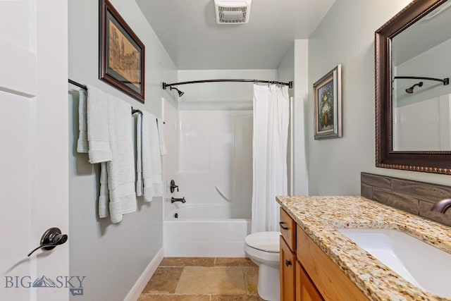 1708 Drummond Blvd, Belgrade, MT 59714 - bathroom featuring baseboards, toilet, vanity, shower / bath combo, and stone finish floors