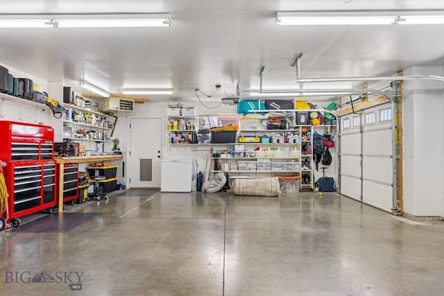 1708 Drummond Blvd, Belgrade, MT 59714 - garage featuring a workshop area and fridge