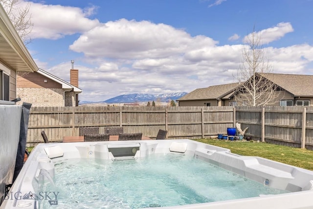 1708 Drummond Blvd, Belgrade, MT 59714 - view of swimming pool with a hot tub, fence, and a mountain view