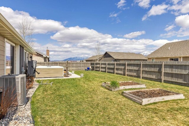 1708 Drummond Blvd, Belgrade, MT 59714 - view of yard featuring a hot tub, cooling unit, a garden, and a patio area