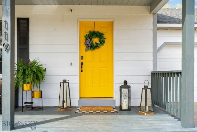 doorway to property featuring roof with shingles