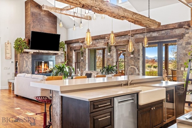 31 Haystack Dr, Bozeman, MT 59718 - kitchen featuring dark brown cabinetry, open floor plan, stainless steel dishwasher, and a sink
