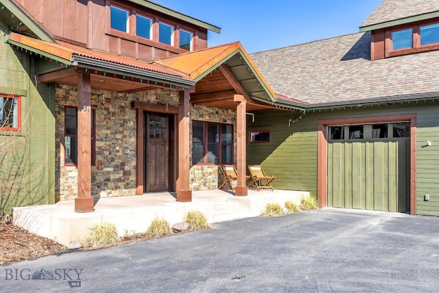 31 Haystack Dr, Bozeman, MT 59718 - doorway to property with stone siding and a shingled roof