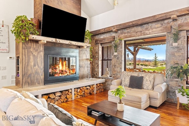 31 Haystack Dr, Bozeman, MT 59718 - living room featuring a high end fireplace, vaulted ceiling, and wood finished floors