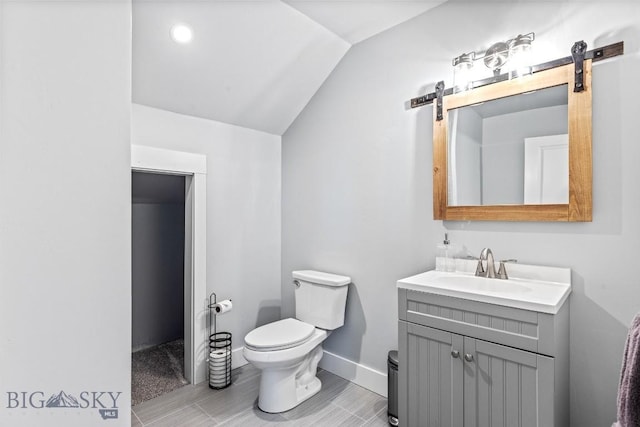 31 Haystack Dr, Bozeman, MT 59718 - bathroom with lofted ceiling, baseboards, vanity, and toilet