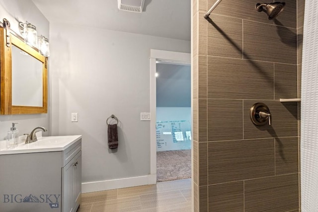 31 Haystack Dr, Bozeman, MT 59718 - full bathroom featuring baseboards, vanity, tiled shower, and visible vents