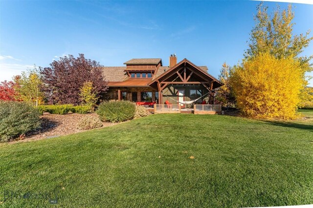 31 Haystack Dr, Bozeman, MT 59718 - back of property featuring a chimney and a yard