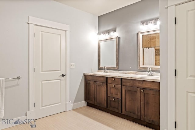 31 Haystack Dr, Bozeman, MT 59718 - full bath featuring baseboards, a sink, double vanity, and curtained shower