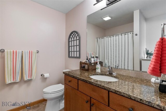 268 Pine Creek Dr, Bozeman, MT 59718 - full bathroom featuring toilet, vanity, a shower with shower curtain, and baseboards