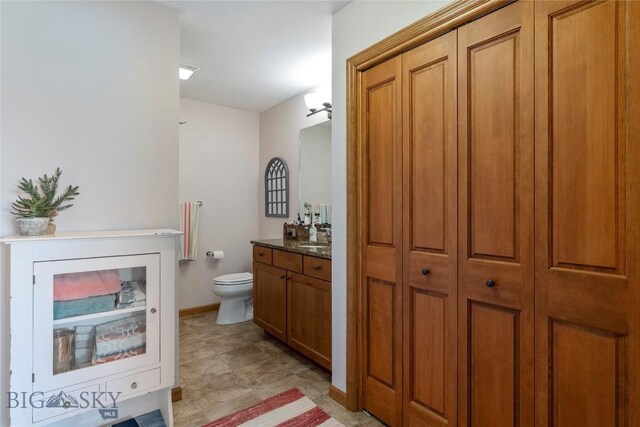 268 Pine Creek Dr, Bozeman, MT 59718 - bathroom with baseboards, toilet, and vanity