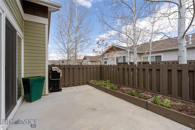 268 Pine Creek Dr, Bozeman, MT 59718 - view of patio featuring area for grilling, a fenced backyard, and a residential view