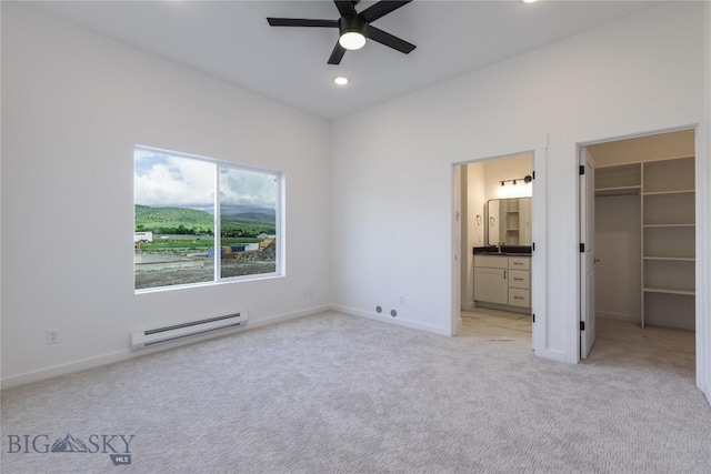 209 Pearl St, Ennis, MT 59729 - unfurnished bedroom with a baseboard radiator, light carpet, a walk in closet, recessed lighting, and baseboards