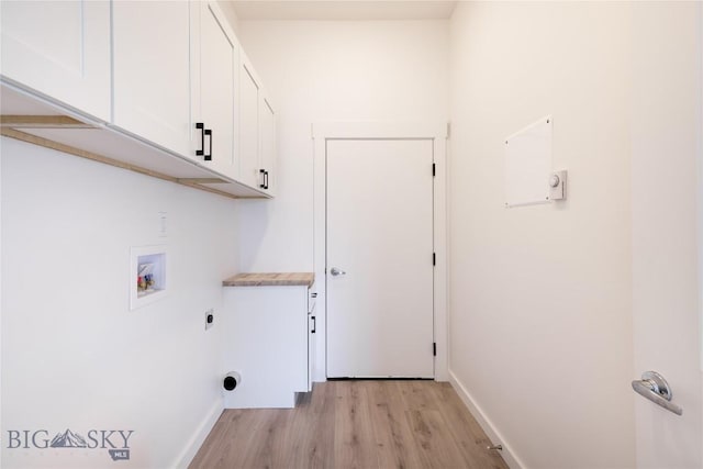 209 Pearl St, Ennis, MT 59729 - washroom featuring electric dryer hookup, cabinet space, washer hookup, light wood finished floors, and baseboards