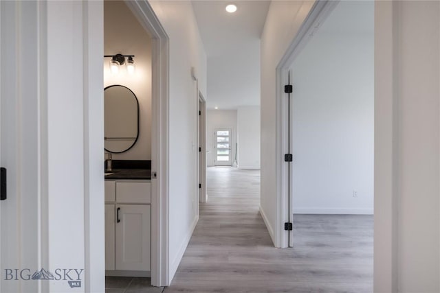 209 Pearl St, Ennis, MT 59729 - hallway featuring light wood-type flooring, baseboards, and recessed lighting