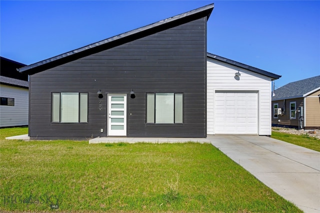 209 Pearl St, Ennis, MT 59729 - view of front of house featuring concrete driveway, a garage, and a front yard