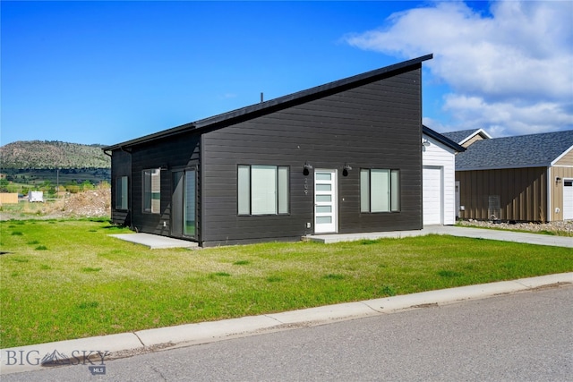 209 Pearl St, Ennis, MT 59729 - view of front of property featuring a front lawn and a garage