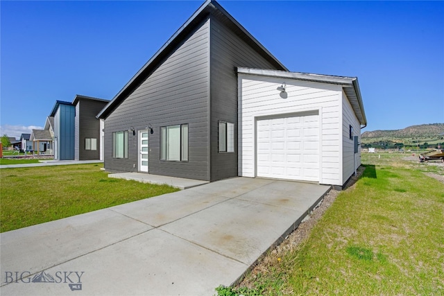 209 Pearl St, Ennis, MT 59729 - view of front of house with a front yard, concrete driveway, and a garage