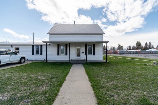 602 Harris, Big Timber, MT 59011 - view of front of property featuring covered porch, a front yard, and metal roof