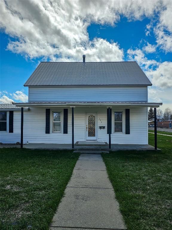 602 Harris, Big Timber, MT 59011 - view of front of home with covered porch, a front lawn, and metal roof