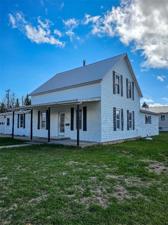 602 Harris, Big Timber, MT 59011 - view of front of house featuring covered porch, a front yard, and metal roof