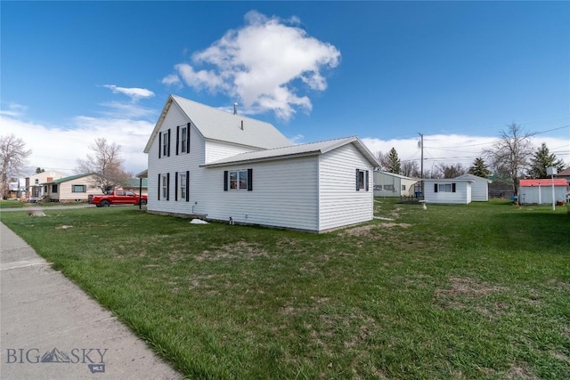 602 Harris, Big Timber, MT 59011 - view of side of home featuring a lawn and metal roof