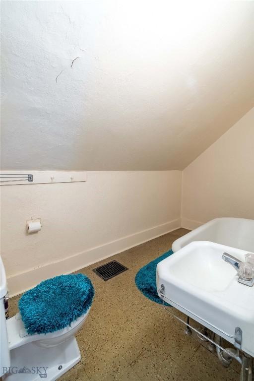 602 Harris, Big Timber, MT 59011 - bathroom featuring baseboards, visible vents, and a sink