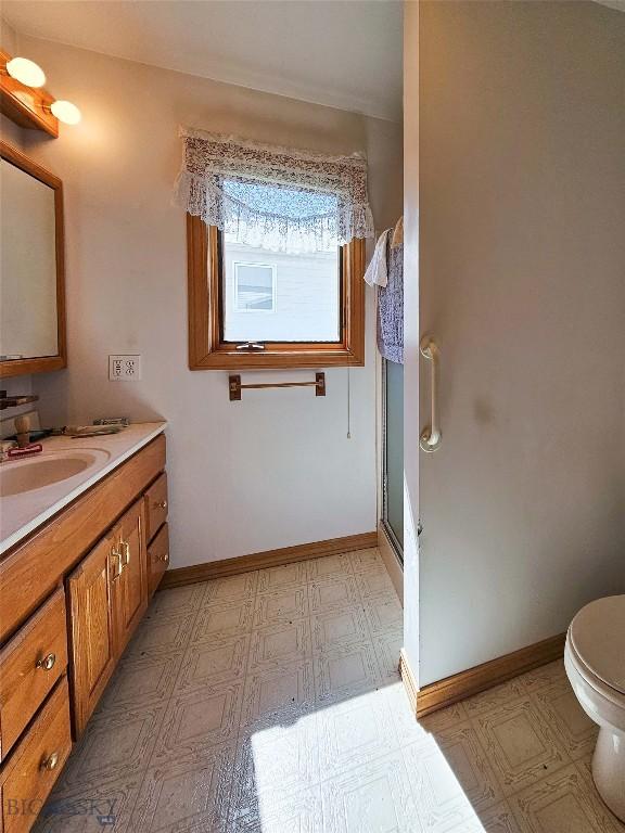 602 Harris, Big Timber, MT 59011 - bathroom featuring baseboards, vanity, a shower stall, and toilet
