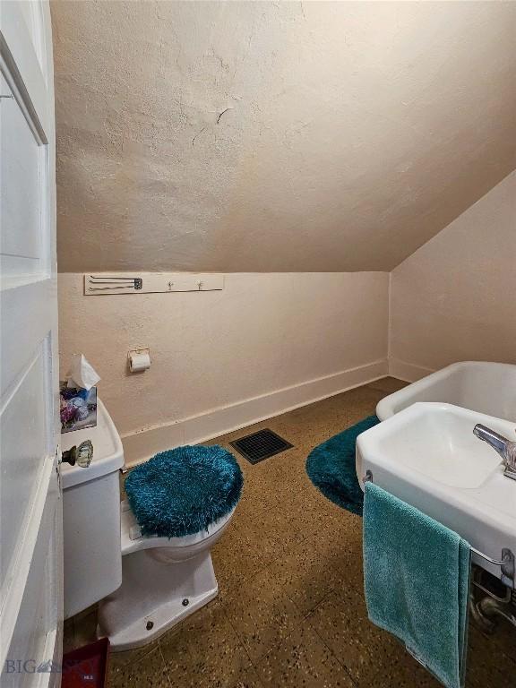 602 Harris, Big Timber, MT 59011 - bathroom with baseboards, visible vents, a textured ceiling, and a sink