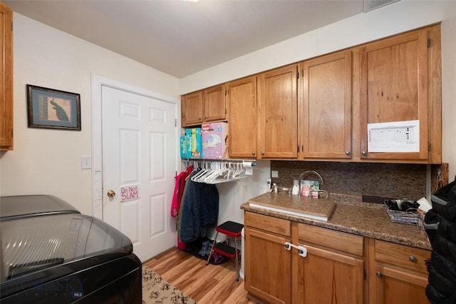 682 E River Rd, Pray, MT 59065 - washroom with light wood-style flooring and cabinet space