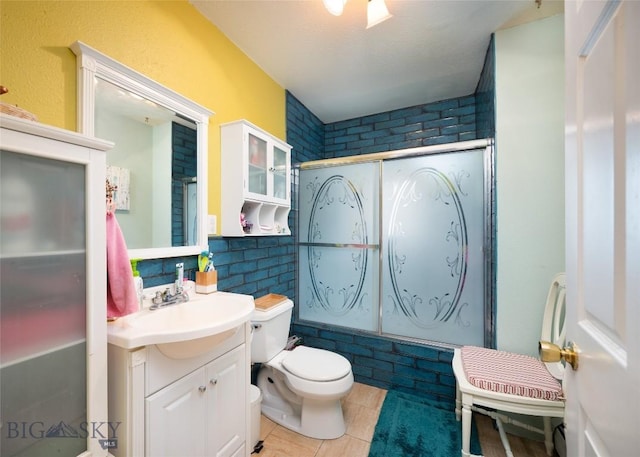 682 E River Rd, Pray, MT 59065 - full bath featuring enclosed tub / shower combo, tile patterned floors, vanity, and toilet