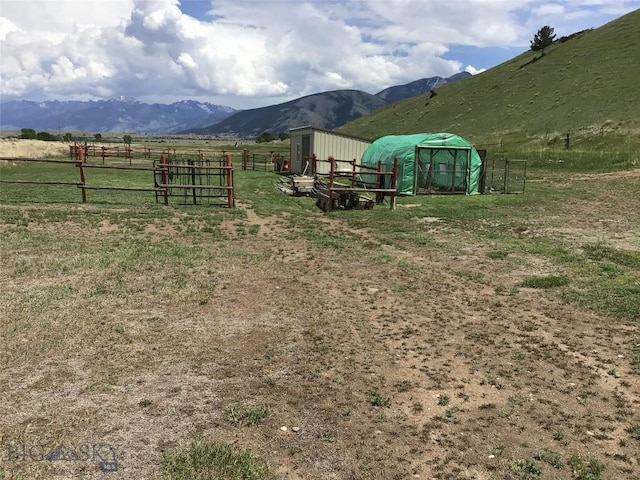 682 E River Rd, Pray, MT 59065 - view of yard with a rural view, a mountain view, fence, an outbuilding, and a pole building