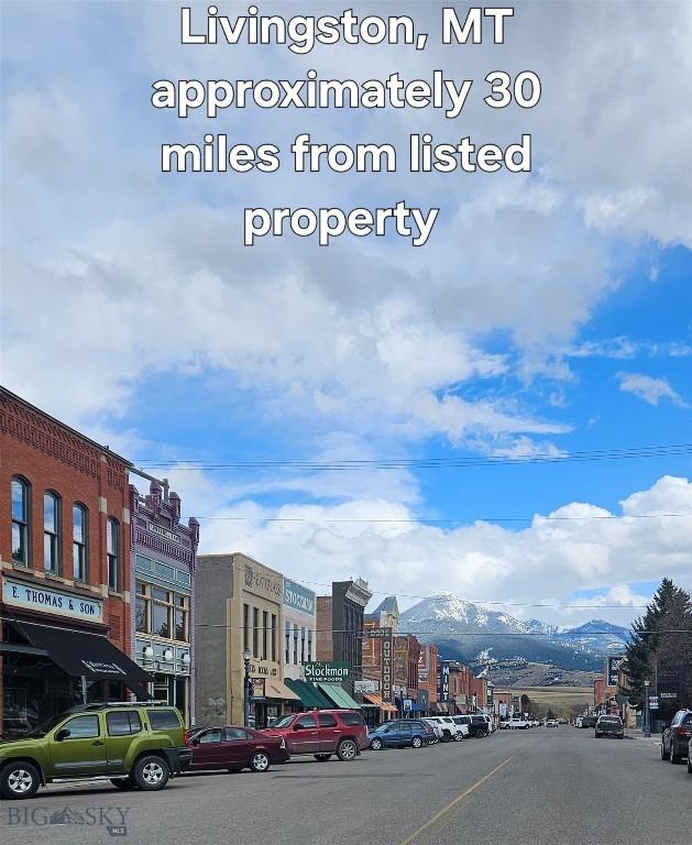 682 E River Rd, Pray, MT 59065 - view of asphalt street with a mountain view and street lighting