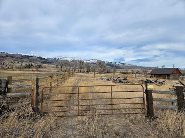 682 E River Rd, Pray, MT 59065 - gate featuring a view of rural / pastoral area, fence, and a mountain view