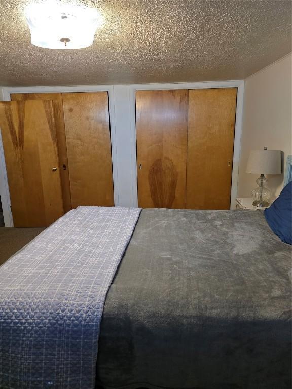 606 S Arizona, Dillon, MT 59725 - bedroom featuring two closets and a textured ceiling