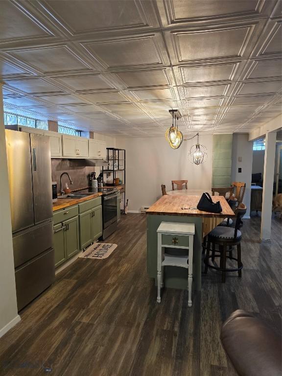 606 S Arizona, Dillon, MT 59725 - dining space with an ornate ceiling, dark wood-style floors, and baseboards