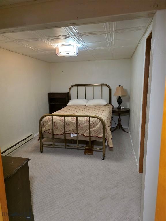 606 S Arizona, Dillon, MT 59725 - bedroom with a baseboard radiator, carpet floors, and baseboards