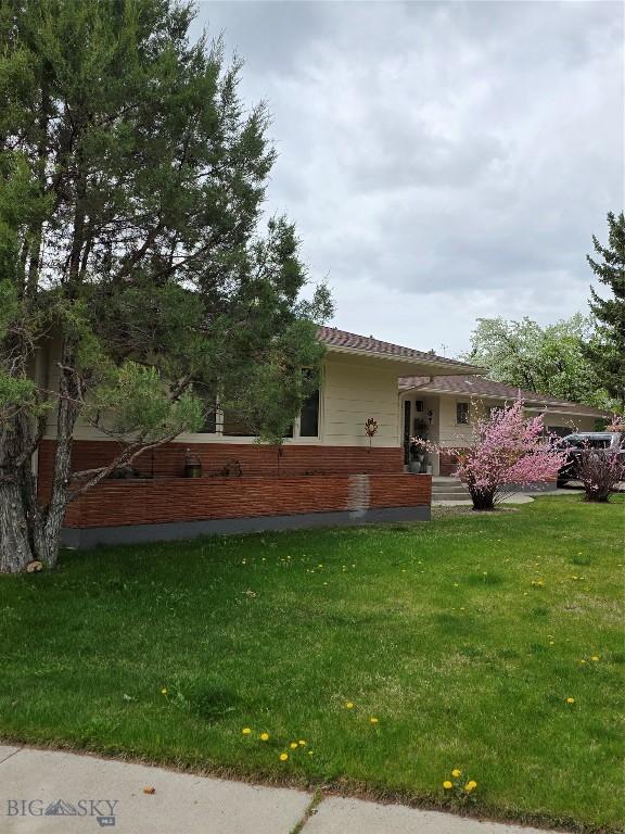 606 S Arizona, Dillon, MT 59725 - back of property with a lawn and brick siding