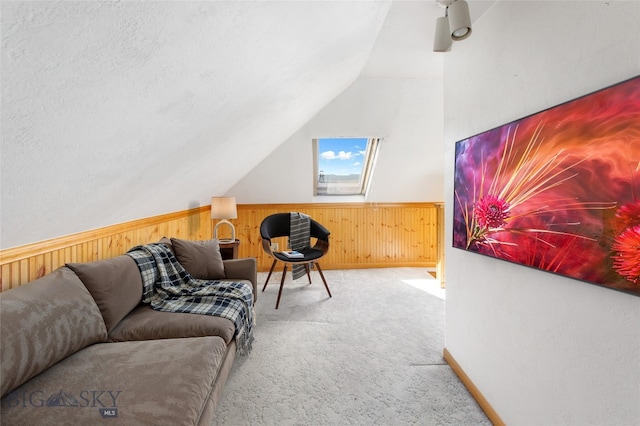 797 Hornet, Butte, MT 59701 - carpeted living room featuring wooden walls, a wainscoted wall, and lofted ceiling