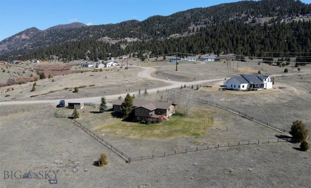 exterior space with a wooded view, a mountain view, and a rural view