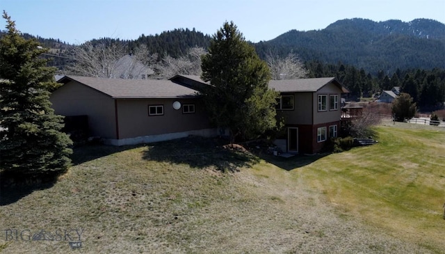 exterior space with a mountain view and a yard