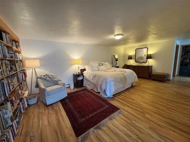 bedroom with wood finished floors