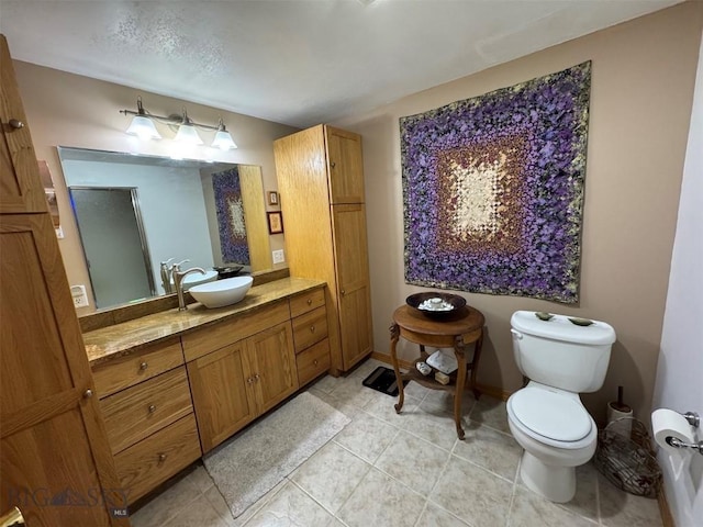 bathroom with tile patterned floors, vanity, and toilet