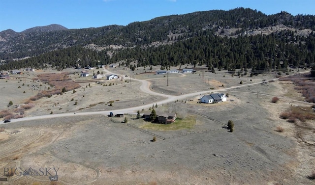 aerial view featuring a mountain view and a wooded view