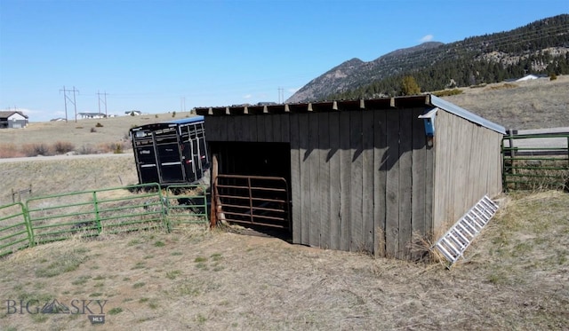 view of outdoor structure with an outdoor structure, a mountain view, and an exterior structure
