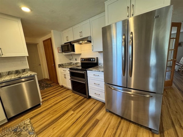kitchen with wood finished floors, stainless steel appliances, white cabinets, and under cabinet range hood