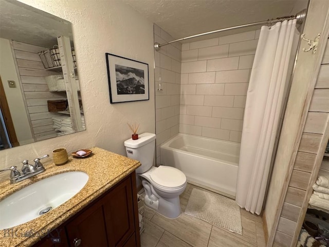 bathroom featuring shower / bathtub combination with curtain, toilet, a textured wall, vanity, and a textured ceiling