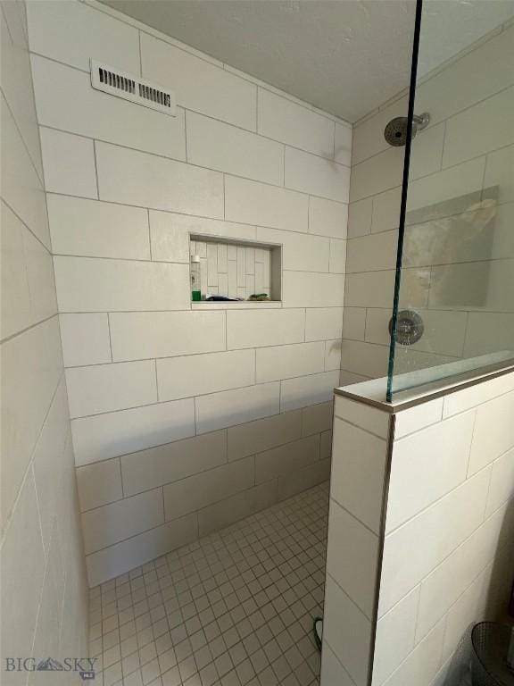 bathroom featuring visible vents, walk in shower, and tile patterned flooring
