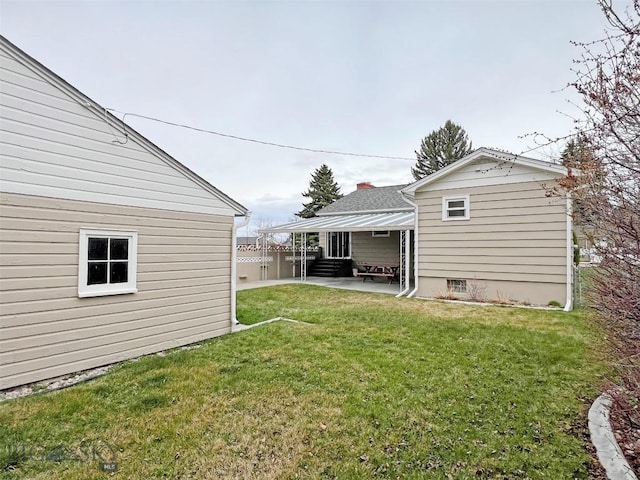 view of yard with a patio, entry steps, and fence